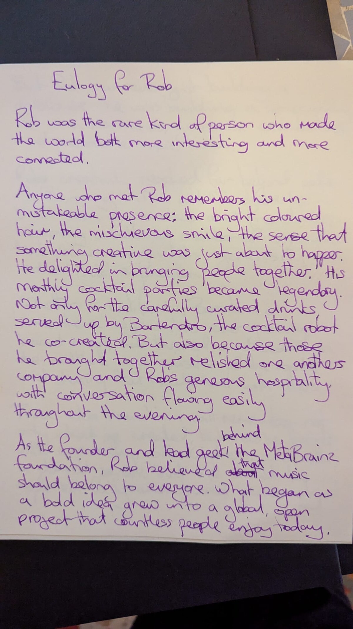 First page of a handwritten eulogy for Rob in purple ink on white paper, beginning with the words Eulogy for Rob.
